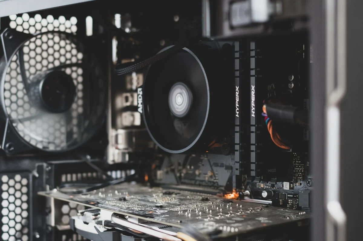 Computer motherboard with a CPU cooler and installed RAM sticks