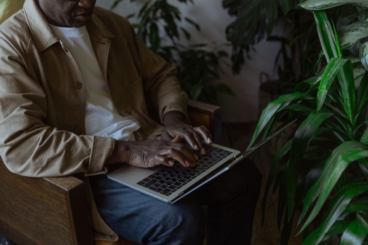 Person using laptop in quiet environment demonstrating focused digital habits for security